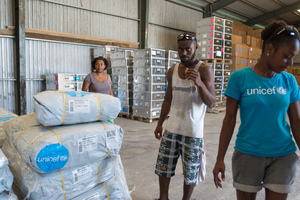 Staff and volunteers wrangle over 90 tonnes of newly arrived emergency supplies at the UNICEF warehouse near Port Vila, Vanuatu. The influx of supplies required the construction of a new temporary storage facility as well.
