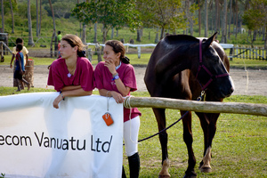 Two young women watching the show jumping competition at Club Hippique near Port Vila.
